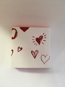 Matchbox style box with red drawer and white sleeve , decorated with red hearts.